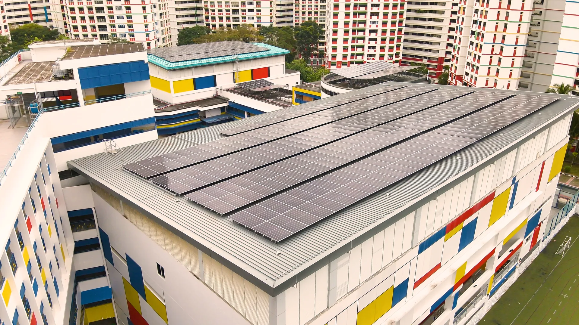 Featured projects, Sembawang Primary School with rooftop PV array, characteristic Mondrian-style facade and HDB residential context